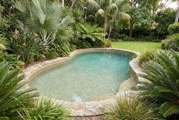 Modern rectangular pool with a charcoal pebble finish