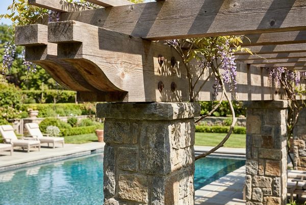 Poolside pergola lit softly for an evening gathering