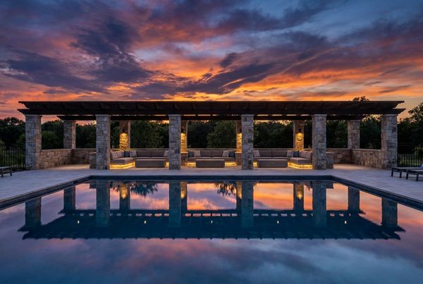 Pergola with integrated downlighting reflected in the pool
