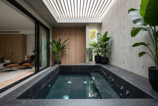 Plunge pool with built-in spa jets and a bench seat for hydrotherapy