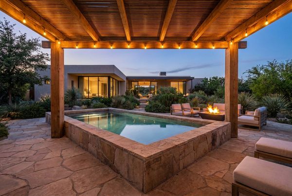 Plunge pool at dusk lit with warm string lights overhead