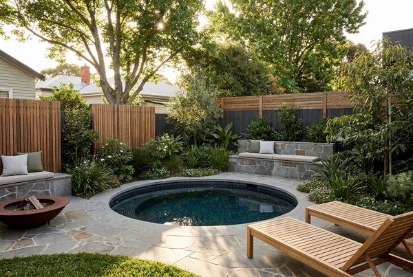 Plunge pool raised above grade with a wood deck surround
