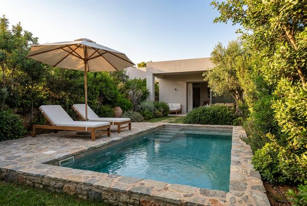 Plunge pool on a sloped lot with a retaining wall backdrop