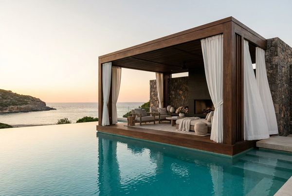 Modern white pool cabana with flowing sheer curtains beside the water