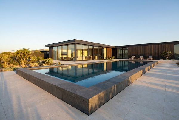 Contrasting dark coping framing a light pool deck