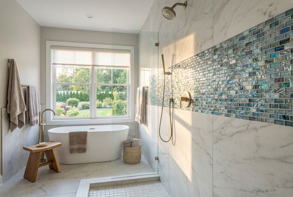 Pool coping above a glass-tile waterline band