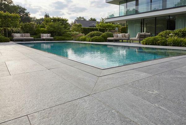Large-format grey porcelain paver pool deck with tight joints