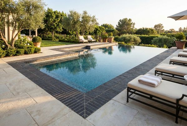 Pool deck with a contrasting soldier-course paver border