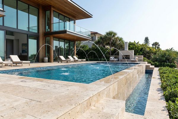 Pool deck with laminar deck jets arcing over the water