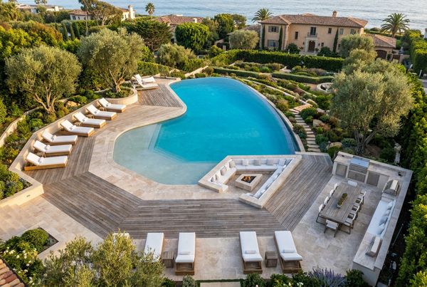 Swimming pool deck with grey porcelain and glass railing