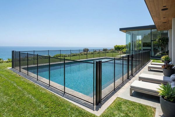 Removable mesh safety fence installed around a family pool