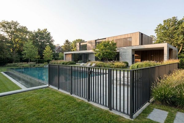 Modern black aluminum pool fence against clean concrete decking