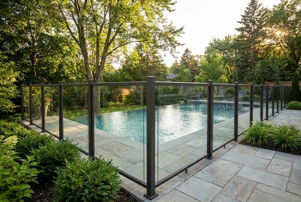 Black aluminum fence enclosing a rectangular backyard pool