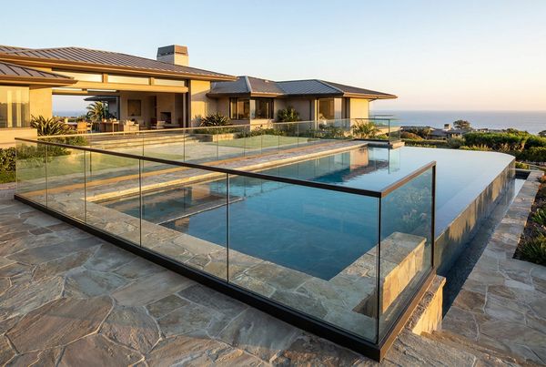 Frameless glass pool fence with an unbroken view of the water