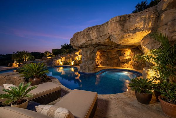 Tropical pool grotto surrounded by palms and lush planting