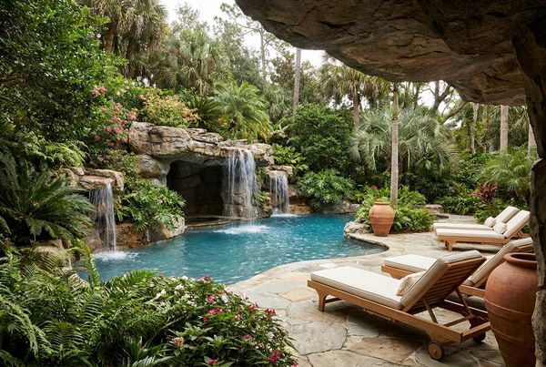 Pool grotto with an integrated rock slide winding down the boulders
