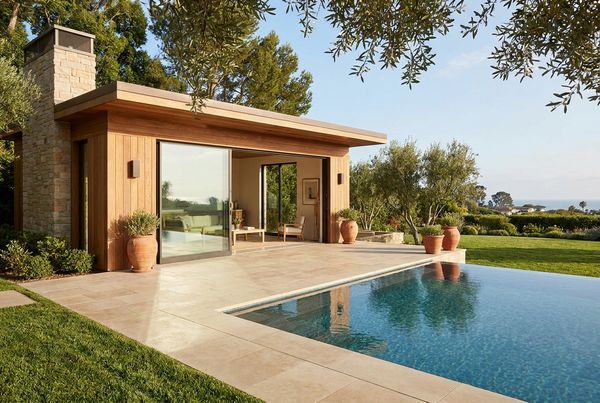 Freestanding pool house set beside a rectangular pool