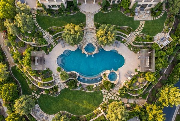 Modern pool bordered by ornamental grasses and agave