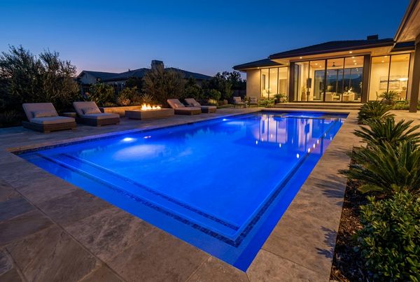 Pool glowing deep blue with LED lights at night