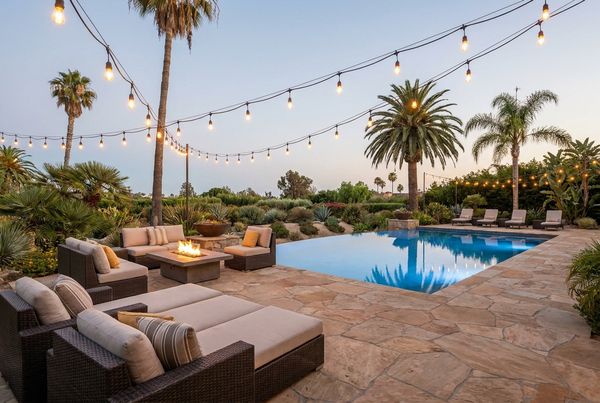 Layered pool and landscape lighting providing both mood and safe wayfinding