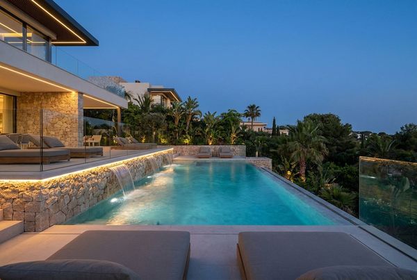 Lit water features flowing into a glowing pool