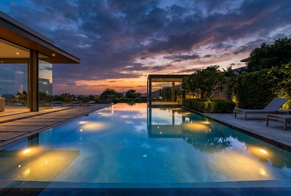 Modern pool at twilight with layered lighting