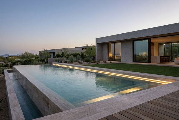 Spa spillover glowing at the pool edge at night