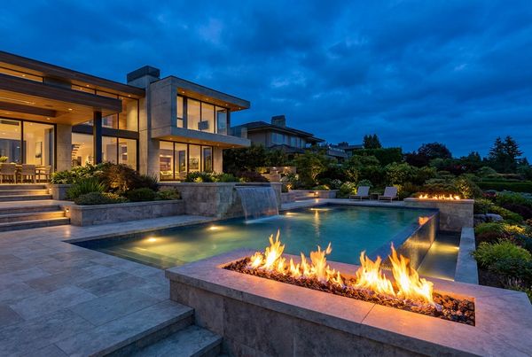 Backyard pool lit for an evening gathering