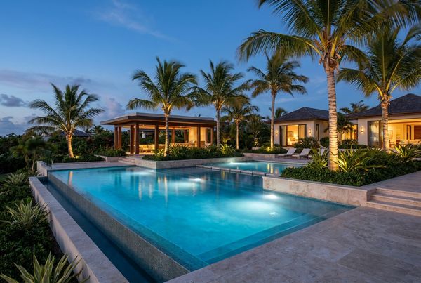 Backyard pool glowing under a starlit sky