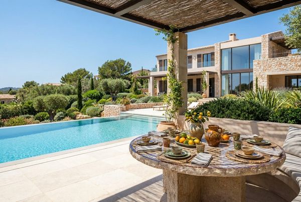 Decorated party table set beside a backyard pool with drinks and food