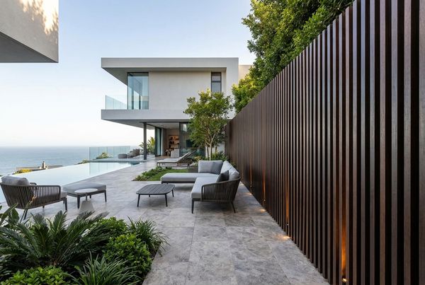 Horizontal wood slat privacy wall behind a modern pool