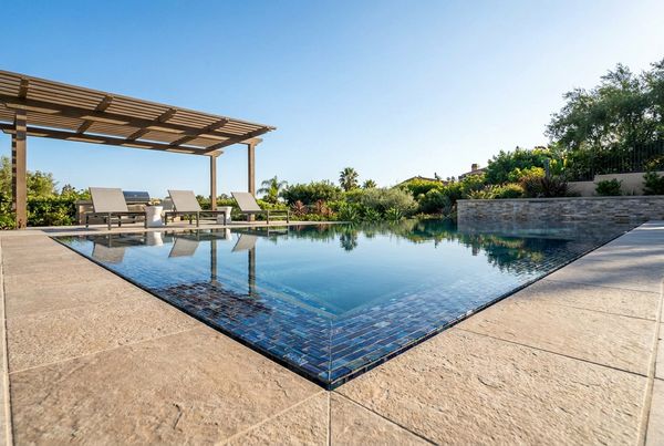 New waterline tile and modern coping installed during a pool remodel