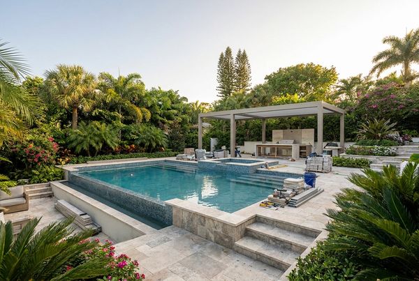 Renovated pool with a modern fire bowl feature