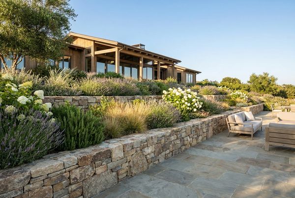 Tiered retaining walls with planted terraces stepping down to a pool