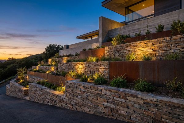 Pool retaining wall glowing at dusk with warm integrated lighting