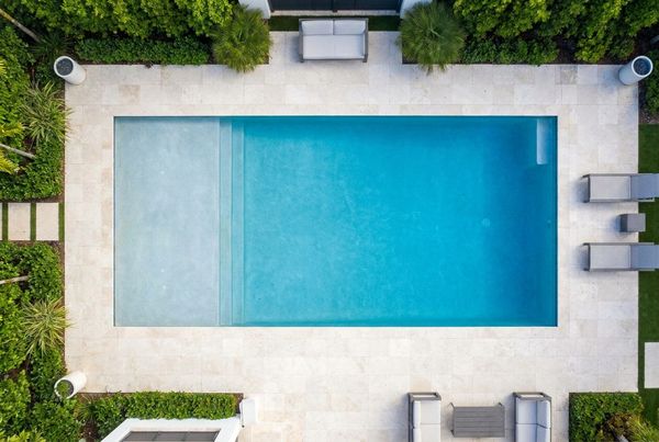 Aerial view of a rectangle pool with a tanning shelf