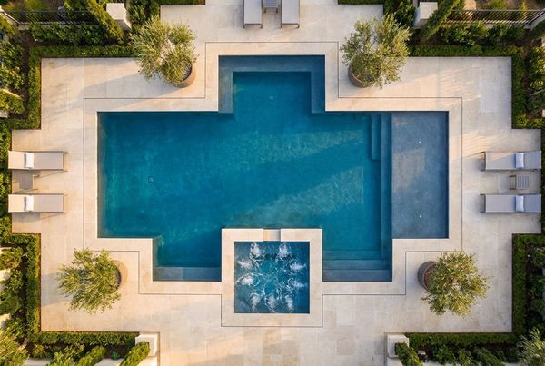 Aerial view of a geometric pool with a matching square spa