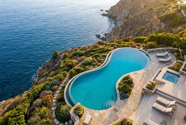 Aerial view of an infinity-edge pool overlooking a view