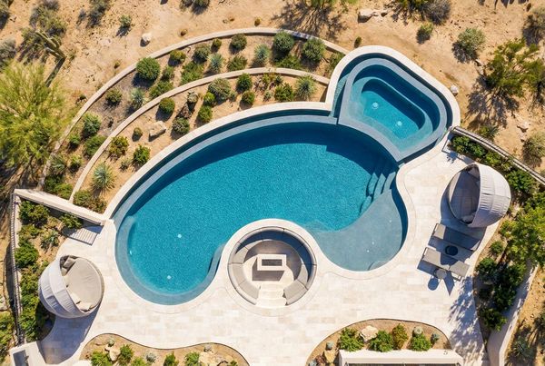 Aerial view of a freeform pool with a rock waterfall