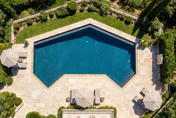 Aerial view of a kidney-shaped pool with a curved spa