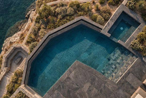 Aerial view of a geometric pool with a square spa