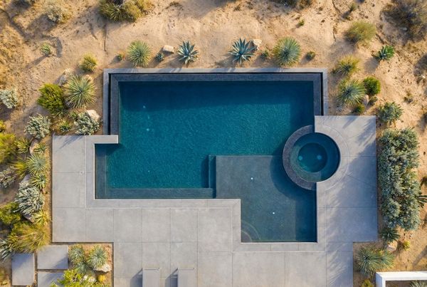 Aerial view of a modern pool with a linear spillover spa