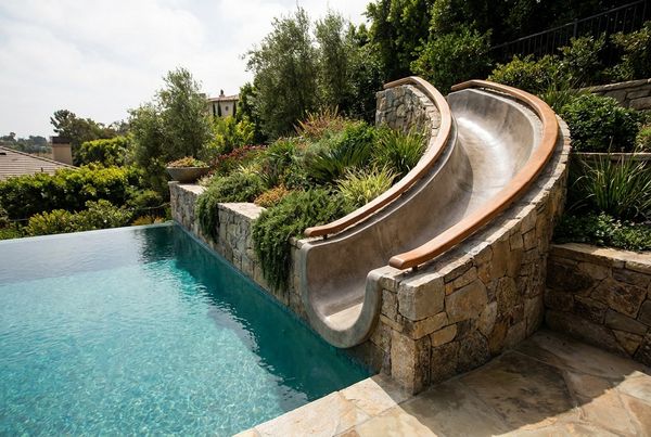 Close-up of a curved pool slide flume showing the smooth gelcoat surface