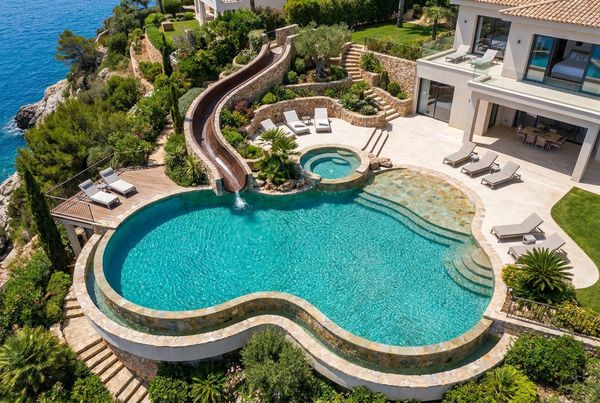 Modern rectangular pool with a straight gray slide and clean lines
