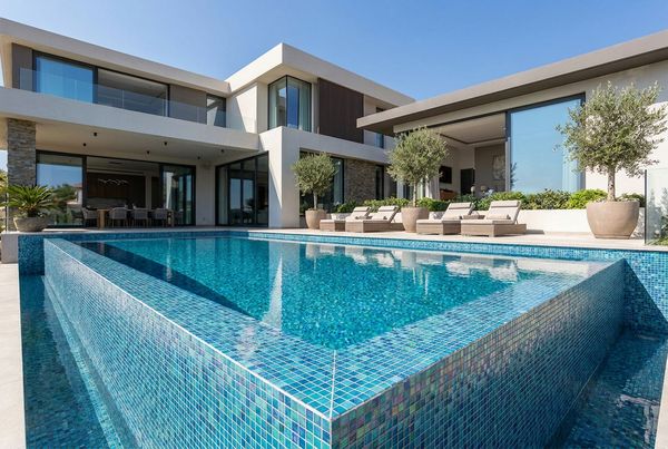Full glass-tile pool interior glowing deep blue
