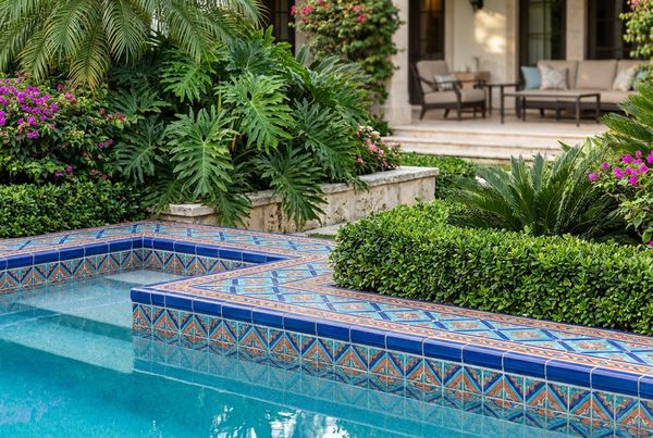 Geometric patterned pool tile in a modern backyard