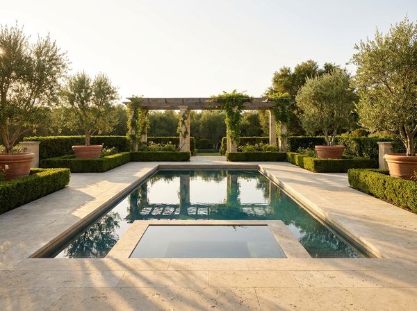 Classic rectangle pool with tanning shelf and travertine deck