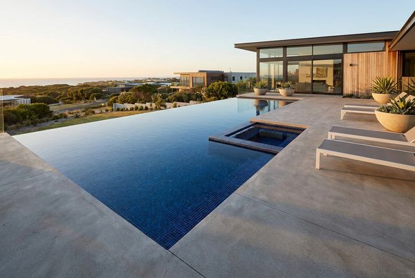 Modern saltwater pool with clean lines, dark coping and clear blue water