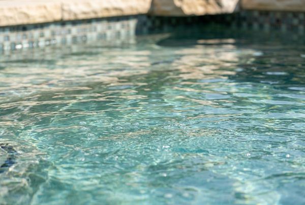 Close-up of clear saltwater pool water with soft ripples and light reflections