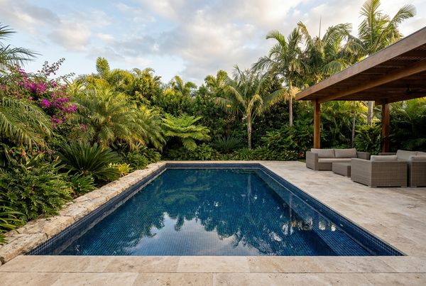 Mediterranean-style saltwater pool with tile waterline and stone coping